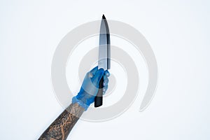 A man hand and gestures in Blue rubber glove shows knife isolated on white background