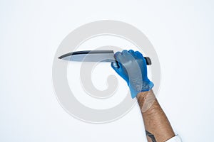 A man hand and gestures in Blue rubber glove shows knife isolated on white background
