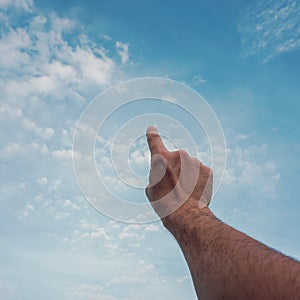 man hand gesturing on the blue sky