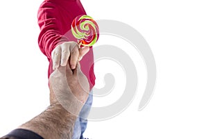 Man hand give candy to child