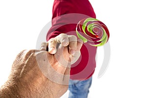 Man hand give candy to child