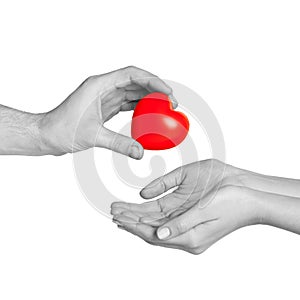 Man hand giving red heart to woman