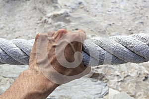 Man hand grab grip strong big aged rope photo