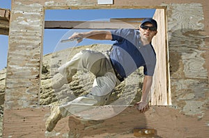 Man With Hand Gun Jumping Obstacle At Firing Range