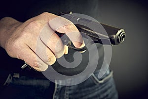 Man with hand gun pistol rubber attack violence. photo