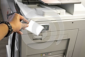 Man hand hold card for scanning key card to access Photocopier Security system concept