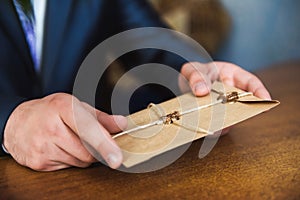 Man hand hold envelope on the wooden background