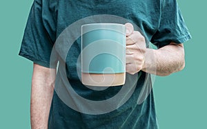 Man hand hold green coffee cup  on green background with clipping path