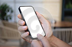 man hand hold phone with isolated screen on background of cafe