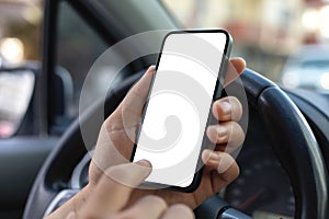 Man hand hold phone with isolated screen steering wheel car