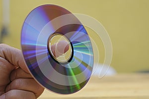Man hand hold an used cd-rom disk, data storage device technology
