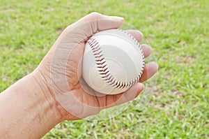 Man hand hold white baseball