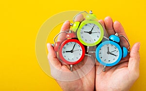 Man hand holding alarm clock