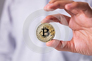 Man hand holding bitcoin. Golden Cryptocurrency bitcoin.
