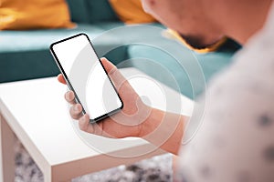 Man hand holding the black smartphone with big blank screen and modern frame less design