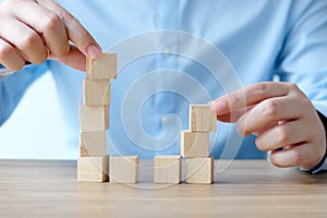 Man hand holding blank wooden cubes on table background, business concept background, template