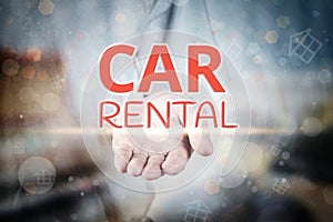 Man hand holding Car Rental text on blurry home icon property ba