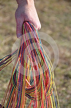 A man hand and holding colorful paracords
