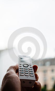 Man hand holding cordless phone calling home office photo