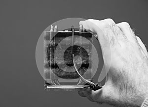 Man hand holding CPU fan heatsink cooler