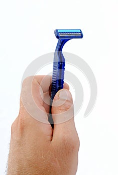 Man hand holding a disposable blue razor