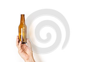 Man hand holding a empty bottle of beer