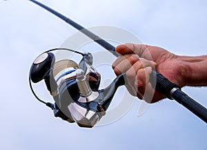 Man hand holding fishing rod