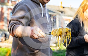 A man hand holding fork with homemade noodles. Lagman. Taditional dish of Middle East cuisine with noodles, beef and vegetables.