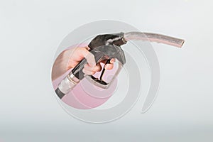 Man hand holding a fuel pump nozzle on colored background