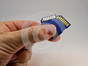 Man hand holding a memory card on a white background. for information technology concept