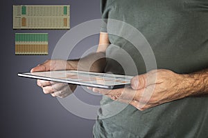 Man hand holding a modern tablet with financial graph.