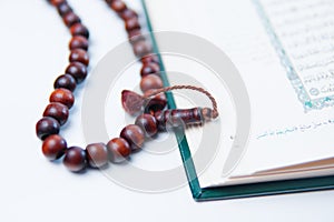 Man hand holding a muslim rosery beads, tasbih with quran asid