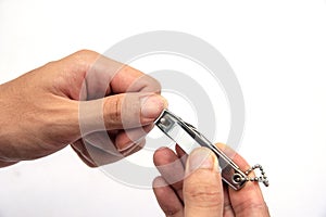 Man hand holding nail scissors to cut manicure.