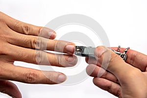 Man hand holding nail scissors to cut manicure.