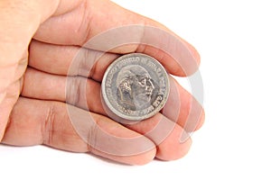 Man hand holding an old Spanish coin of 50 pesetas