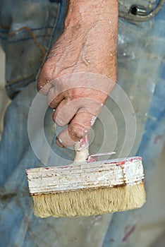 Man hand holding Paint Brush grey background