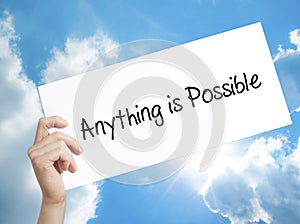 Man Hand Holding Paper with text Anything is Possible . Sign on