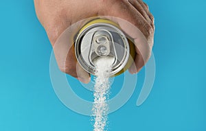 Man hand holding refresh drink can pouring sugar stream in sweet and calories content of soda and energy drinks