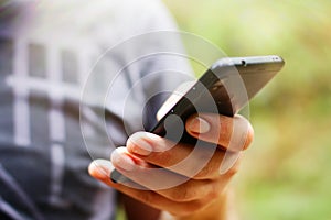 a man hand is holding a smartphone. mobile communication, online shopping, modern gadgets