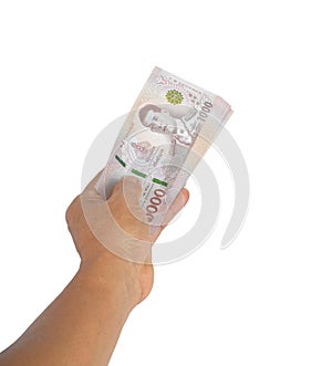 Man hand holding Thai baht thousand banknote isolated on white background