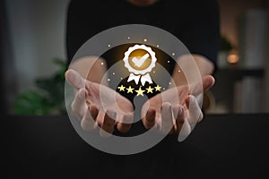 Man hand holding virtual icon providing a five-star premium service. hand man showing award high standards are guaranteed, service