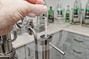 man hand holds an alcohol meter