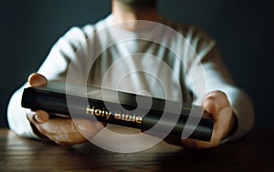 Man hand Holy Bible