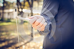 Man hand with jump rope in focus.