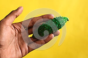 Man hand on karela or bitter gourd,momordica Charantia,wild Bitter Gourd, Bitter Cucumber,copy space with selective focus