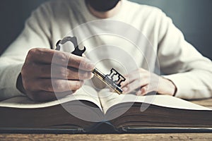 Man hand key and book