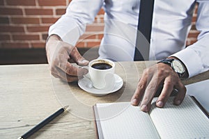 Man hand keyboard with notepad and coffee