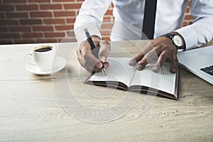 Man hand keyboard with notepad and coffee