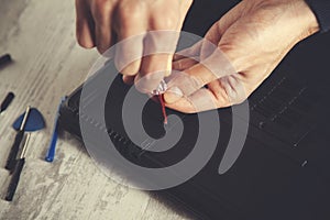 Man hand laptop disassembling