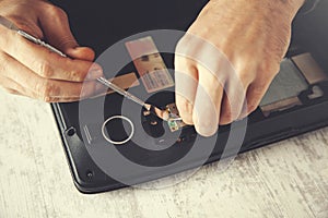Man hand laptop disassembling